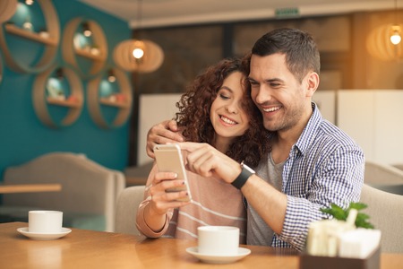 Nice looking couple in cafeの写真素材