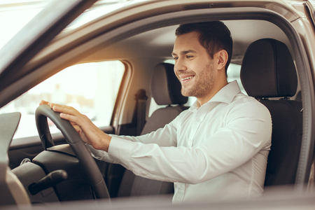 Young Man in a Car Rental Service Test Drive Conceptの写真素材