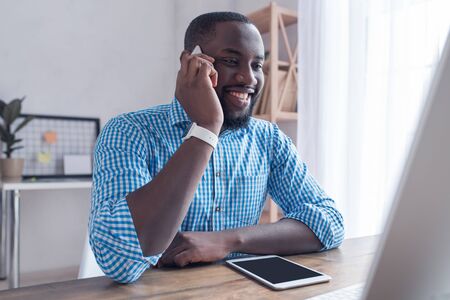 Young african male working in the office business using digital device