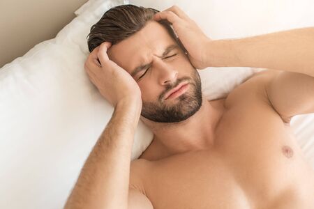 Young man business traveler hotel room accomodationの写真素材