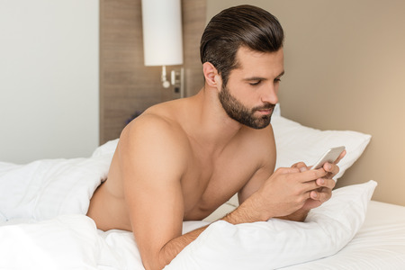 Young man business traveler hotel room accomodationの写真素材