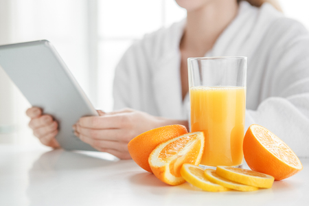 Young woman making detox smoothie at homeの写真素材
