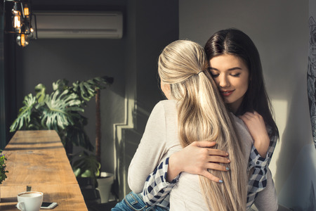 Young women friends in a coffee shop free timeの写真素材