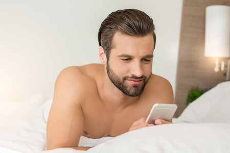 Young man business traveler hotel room accomodationの写真素材