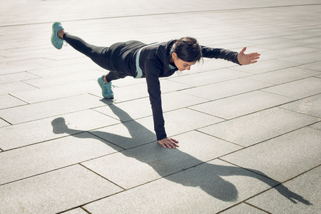 Young woman active exercise workout on street outdoorの写真素材