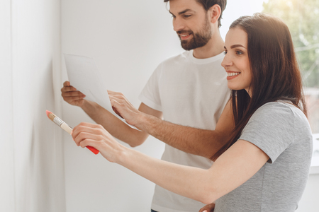 Young couple doing apartment repair together themselvesの写真素材