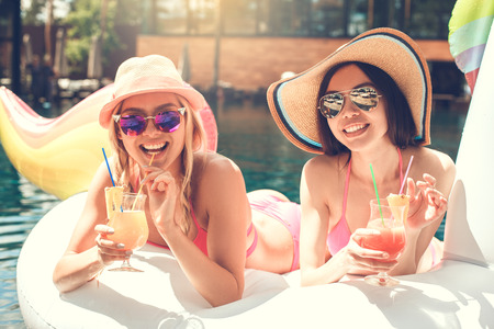 Young women friends in the swimming pool funの写真素材