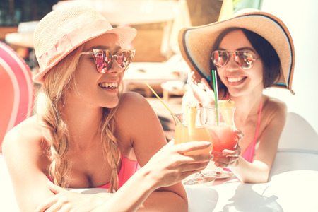 Young women friends in the swimming pool funの写真素材
