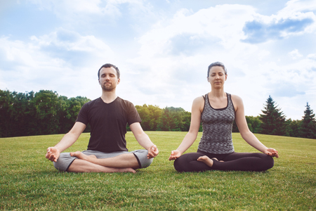 People practice acro yoga outdoors healthy lifestyleの写真素材