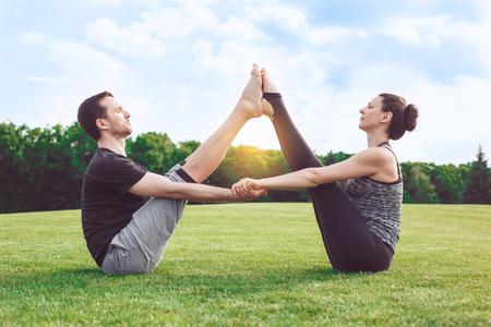 People practice acro yoga outdoors healthy lifestyleの写真素材