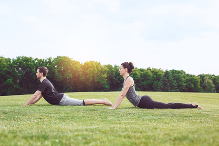 People practice acro yoga outdoors healthy lifestyleの写真素材