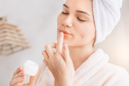 Young woman body care at home indoorsの写真素材