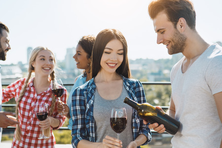 Group of friends having barbecue party on the roofの写真素材