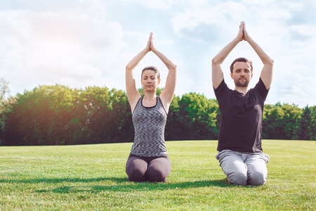 People practice acro yoga outdoors healthy lifestyleの写真素材