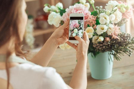 Young woman florist occupation working with flowersの写真素材