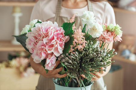 Young woman florist occupation working with flowersの写真素材