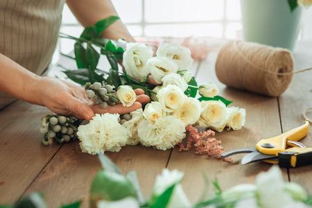 Young woman florist occupation working with flowersの写真素材