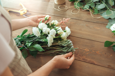 Young woman florist occupation working with flowersの写真素材