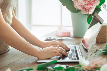 Young woman florist occupation working with flowersの写真素材