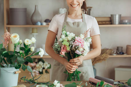 Young woman florist occupation working with flowersの写真素材