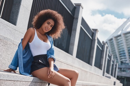 Young woman free style on the street sitting on stairs leaning bの写真素材