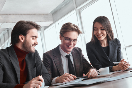 Businesspeople at office working together sitting man playing gaの写真素材