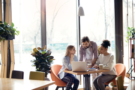 Young people coworking together at creative office sitting browsの写真素材