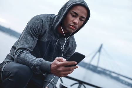 Young male jogger athlete training and doing workout outdoors inの写真素材