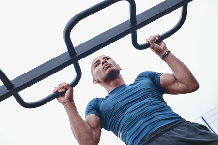 Young male jogger athlete training and doing workout outdoors in
