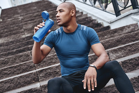 Young male jogger athlete training and doing workout outdoors inの写真素材