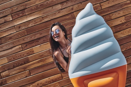 Summer fashion. Girl in swimsuits having fun on vacation. Sexy female model in trendy sunglasses and...
