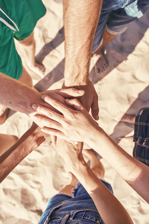 Close up of hands holding together at the beachの写真素材