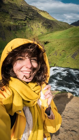 Woman stay on waterfall in Iceland, hide waterfall in Iceland, aの写真素材