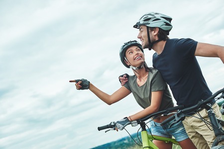 Did you see it. Couple in protection are looking at somethingの写真素材