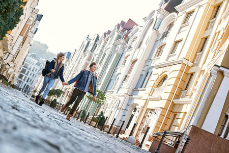 Young couple of travel bloggers are walking around old cityの写真素材