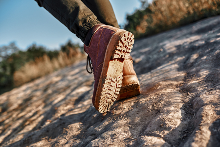Legs of young tourist blogger what walks at mountains. Cropped photoの写真素材