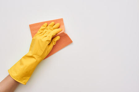 Housewife is cleaning. Cleaner cloth in human hands