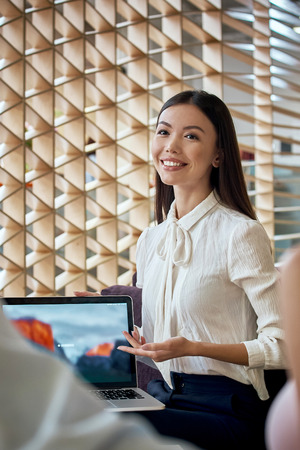 Young travel agent give a presentation to a clientの写真素材
