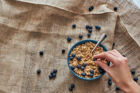 Top view of muesli bowl with blueberries. Diet breakfast in the morning.の写真素材