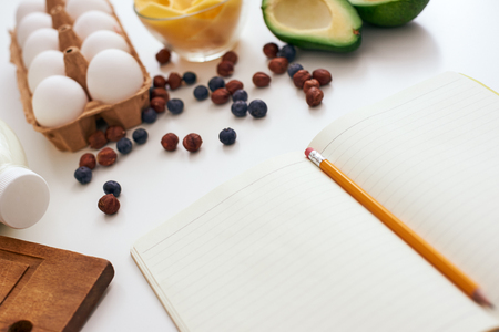 Avocado, dry berries, eggs and cheese, we are ready to write a new healthy recipeの写真素材
