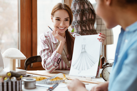 Close-up of stylist coworking in design studio. Creating new design projectの写真素材