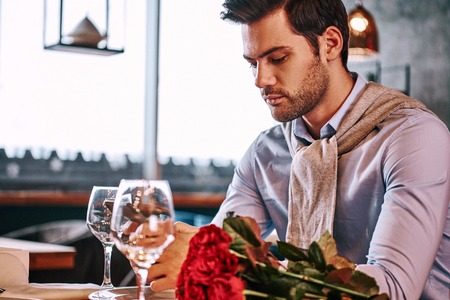 Waiting minutes before a meeting. Close-up of man is chatting while waitingの写真素材