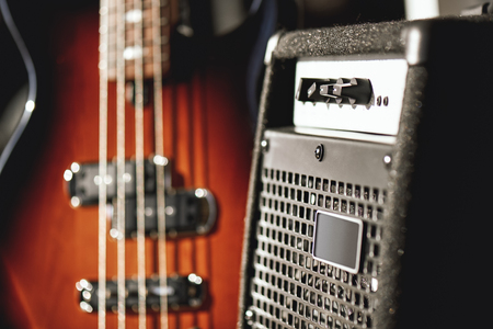 Just perfect sound. Close up view of a brown electric guitar and amplifier standing in audio recording studioの写真素材