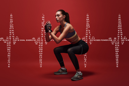 Never give up. Sportswoman standing over red background, stretching her body. Graphic drawing.の写真素材
