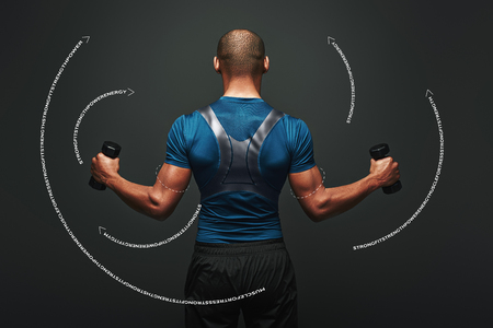 Never give up. Dark skinned sportsman working out with dumbbells over dark background. Graphic drawing.の写真素材