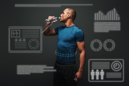 Hydrating. Muscular sportsman drinking water after training. Game concept with graphic drawing.の写真素材