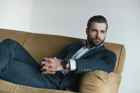 Stylish young man in a suit and bow tie. Business style. Fashionable image.の写真素材