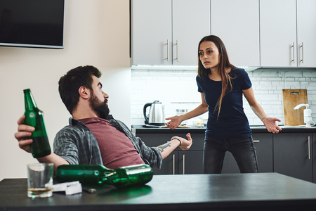 Addiction doesnt kill the addict. It kills the family, kids and people who tried to help! Young family, husband alcoholic, social problems conceptの写真素材