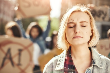 Trust women. Close up photo of young blonde woman is crying while standing in front of female...