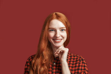 Share your smile with the world. Close up of cheerful pretty young lady smiling at the cameraの写真素材